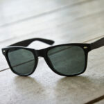 black sunglasses on wood floor